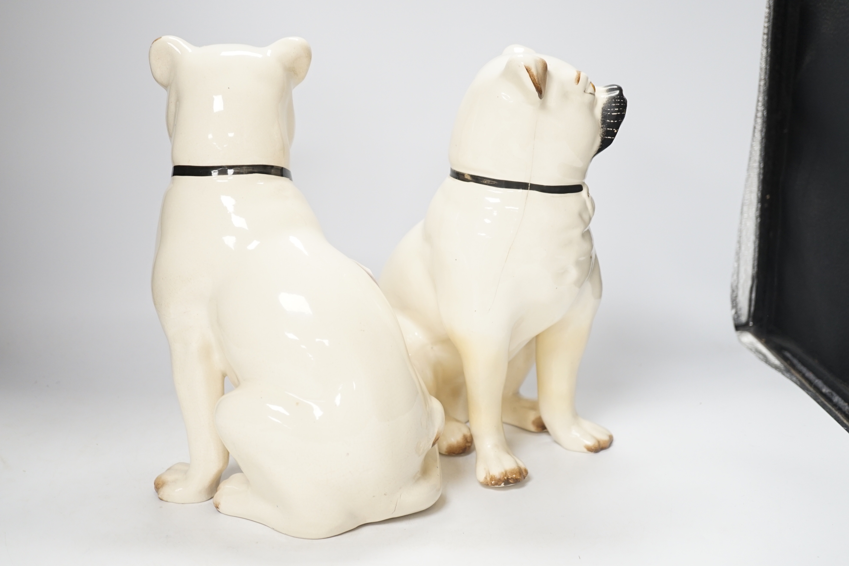 A pair of Staffordshire pug dogs, 28cm high